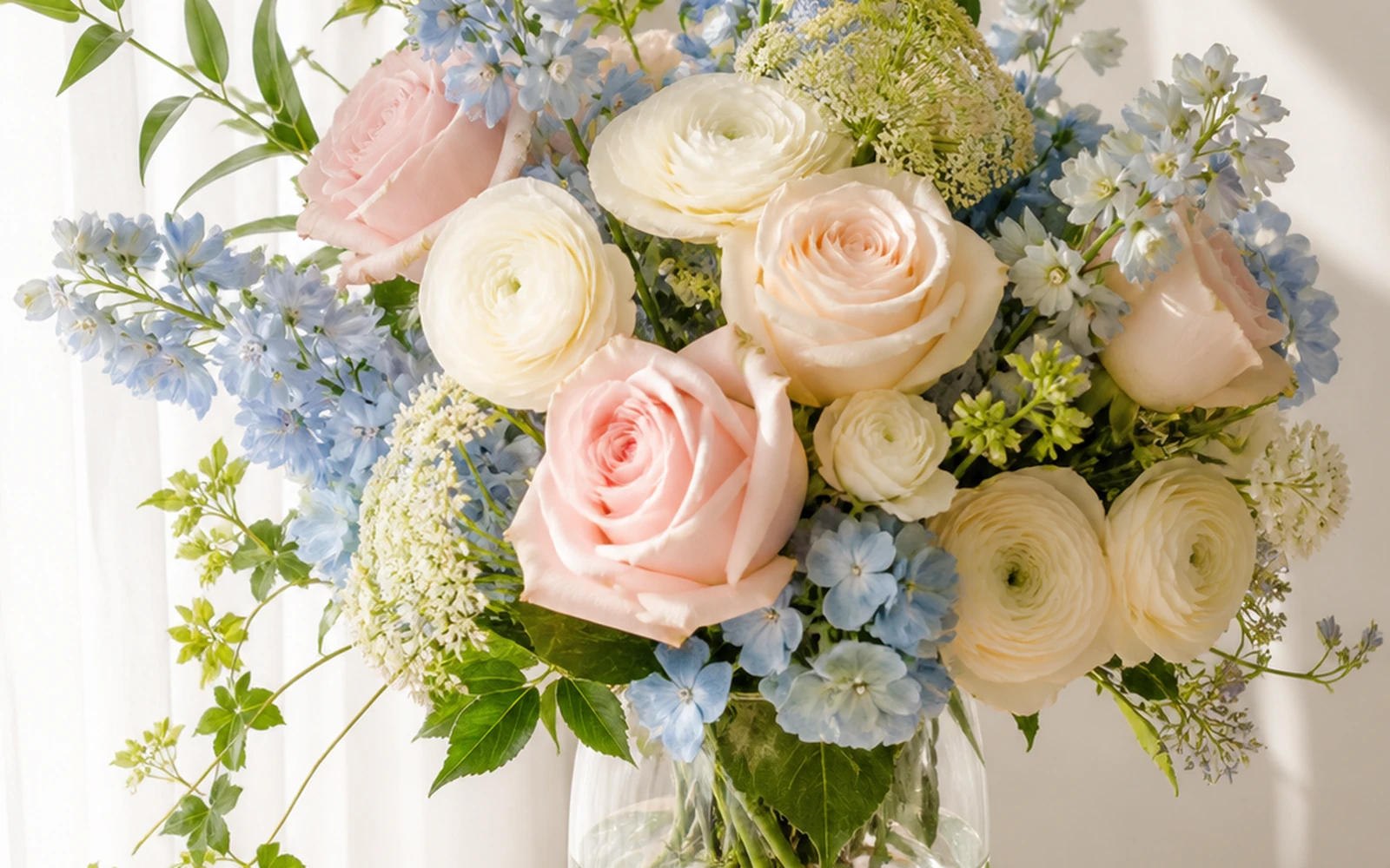 Finished blush, ivory, blue, and green flowers in a ready-to-display vase