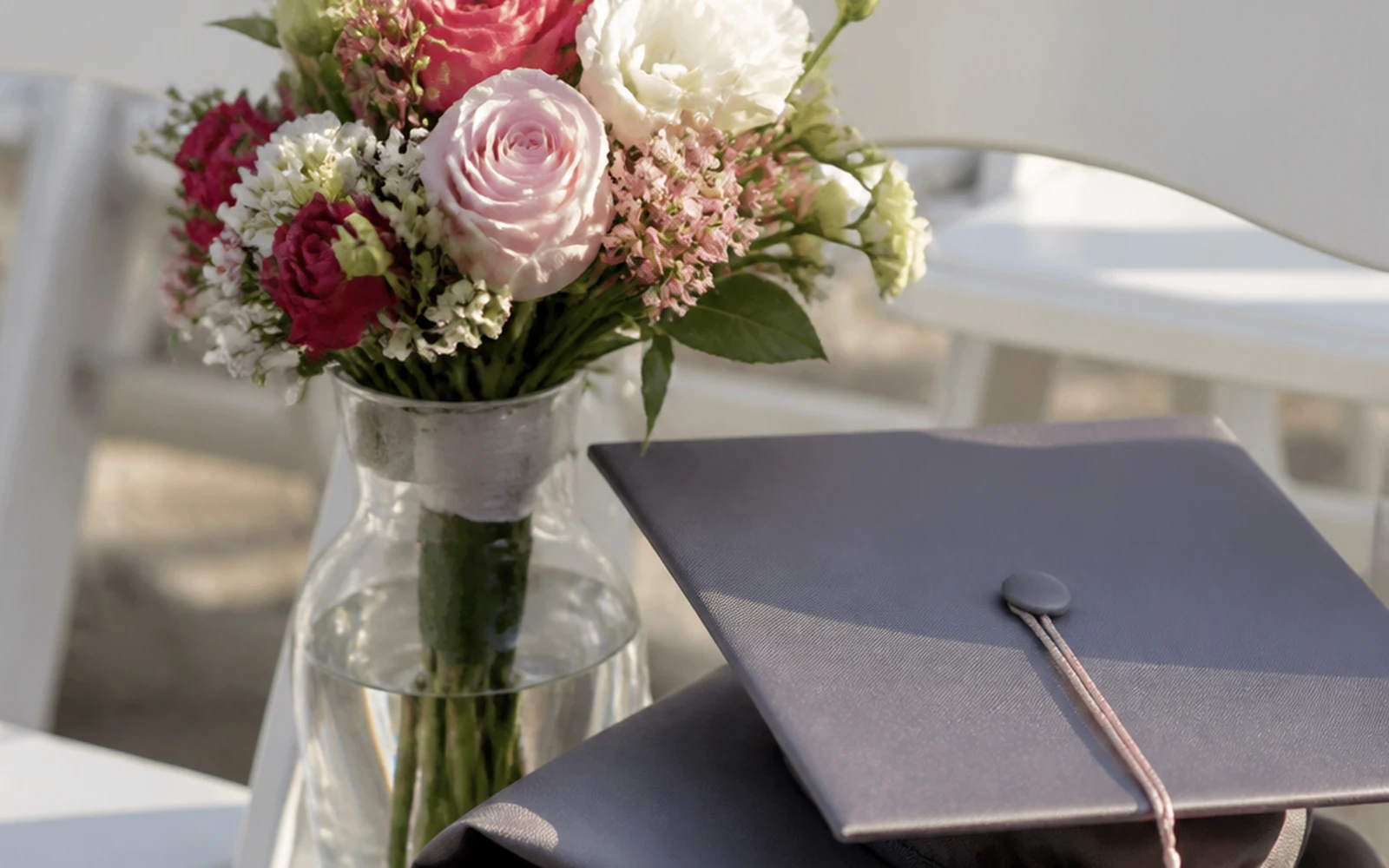 Graduation bouquet resting safely in water beside ceremony seating