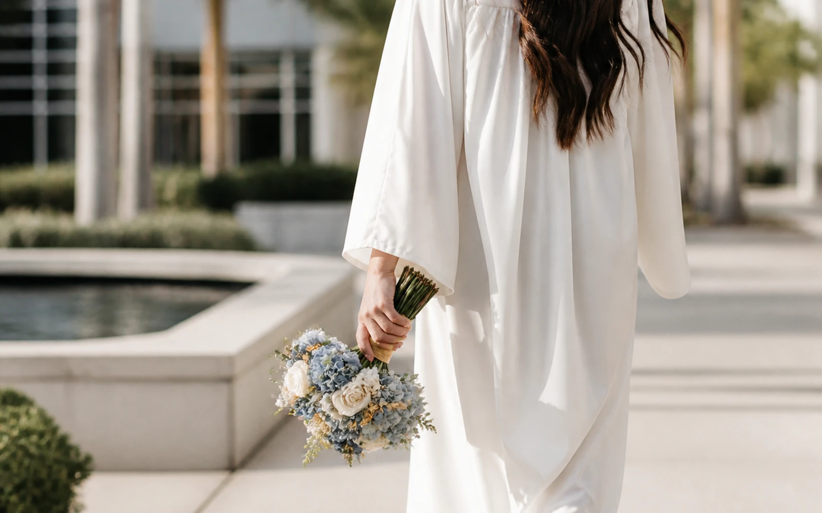 Graduate carrying a compact hand-tied bouquet comfortably after the ceremony