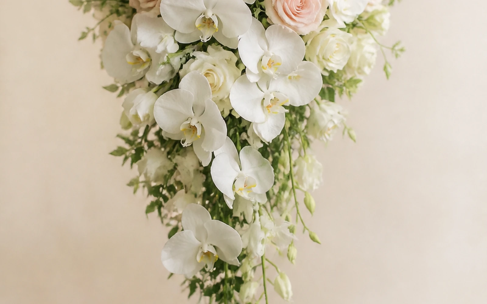 Cascade wedding bouquet with a rounded top flowing into a long taper