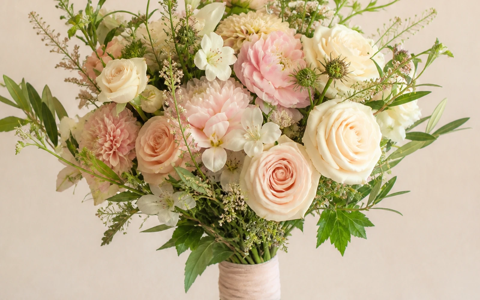 Hand-tied wedding bouquet with a visible binding point and exposed stems