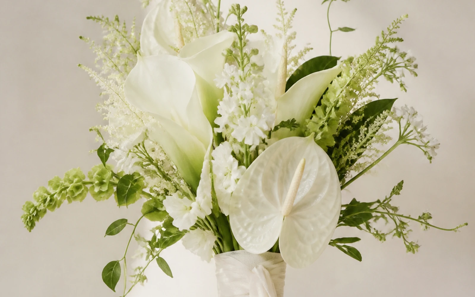 Ivory sculptural wedding bouquet with smooth white flowers and green accents